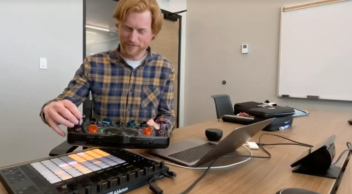 Dr. Adam Patrick Bell, PhD demonstrating a synthesizer